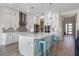 Open concept kitchen with a large island, modern appliances, and stylish pendant lighting at 2011 Soaring Oak Way, Winter Park, FL 32792