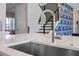 Modern kitchen with stainless steel sink, faucet, and view of staircase at 2011 Soaring Oak Way, Winter Park, FL 32792