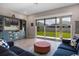 Comfortable living room with large sliding glass doors leading to a well-maintained backyard at 2011 Soaring Oak Way, Winter Park, FL 32792