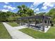 Community picnic area featuring a pergola, tables with benches and concrete path at 2011 Soaring Oak Way, Winter Park, FL 32792