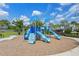 Community playground featuring multiple slides and climbing structures set on a mulch base at 2011 Soaring Oak Way, Winter Park, FL 32792