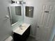 Bathroom with a vanity, mirror, lights, and a door at 214 Magellan Dr, Kissimmee, FL 34758