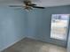 Cozy bedroom featuring tile floors, a ceiling fan, and a window providing natural light at 214 Magellan Dr, Kissimmee, FL 34758
