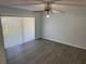 Living room with a ceiling fan, a sliding glass door, and flooring at 214 Magellan Dr, Kissimmee, FL 34758