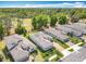 Picturesque aerial view of homes with manicured lawns, solar panels, and beautiful landscaping near golf course at 231 Cherokee Hill Ct, Deland, FL 32724