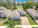 Elegant house with brick driveway and lush landscaping, nestled among trees with a view of golf course at 231 Cherokee Hill Ct, Deland, FL 32724
