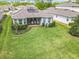 Aerial view of backyard with patio and lush lawn, showcasing the home's outdoor living space at 231 Cherokee Hill Ct, Deland, FL 32724