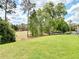 Expansive backyard with a neatly kept lawn and a backdrop of trees offers privacy at 231 Cherokee Hill Ct, Deland, FL 32724
