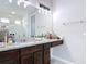 Well-lit bathroom featuring a granite countertop, modern vanity, and a frameless glass shower at 231 Cherokee Hill Ct, Deland, FL 32724