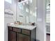 Tastefully decorated bathroom with a granite countertop, dark wood cabinets, and modern fixtures at 231 Cherokee Hill Ct, Deland, FL 32724