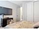 This bedroom features a television, spacious closet, and soft natural light at 231 Cherokee Hill Ct, Deland, FL 32724