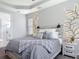 Comfortable bedroom showcasing a decorative accent wall with string lights and a view of the Primary bath at 231 Cherokee Hill Ct, Deland, FL 32724