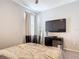 This bedroom features an entertainment center, mirror, and soft natural light at 231 Cherokee Hill Ct, Deland, FL 32724