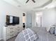 Spacious bedroom featuring a TV, dresser, and calming gray tones with easy access to a walk-in closet at 231 Cherokee Hill Ct, Deland, FL 32724