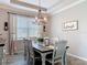 Dining room showcasing an elegant chandelier, modern decor, and stylish furnishings at 231 Cherokee Hill Ct, Deland, FL 32724