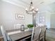 Dining room showcasing an elegant chandelier, modern decor, and stylish furnishings at 231 Cherokee Hill Ct, Deland, FL 32724