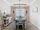 Dining room showcasing an elegant chandelier, modern decor, and stylish furnishings at 231 Cherokee Hill Ct, Deland, FL 32724