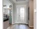 Bright foyer featuring a decorative glass front door and wood-look tile flooring at 231 Cherokee Hill Ct, Deland, FL 32724