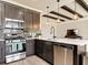 Updated kitchen with stainless steel appliances, shaker style cabinets, tile backsplash, and quartz countertop at 231 Cherokee Hill Ct, Deland, FL 32724