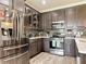 Updated kitchen with stainless steel appliances, shaker style cabinets, tile backsplash, and quartz countertop at 231 Cherokee Hill Ct, Deland, FL 32724
