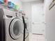 Well-equipped laundry room with modern washer and dryer units and ample shelving for storage at 231 Cherokee Hill Ct, Deland, FL 32724