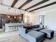 Stylish living area showcasing dark wood beams, an open kitchen, and a comfortable seating arrangement at 231 Cherokee Hill Ct, Deland, FL 32724