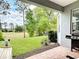 Outdoor patio with a hammock, barbecue, and stunning views of the golf course and mature trees at 231 Cherokee Hill Ct, Deland, FL 32724