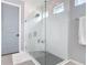 Contemporary glass-enclosed shower with a rainfall showerhead, built-in seat, and modern tiling at 231 Cherokee Hill Ct, Deland, FL 32724
