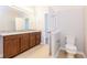 Bright bathroom featuring tile floors, granite countertop, and white toilet at 2430 Sanderling St, Haines City, FL 33844