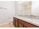 Bathroom featuring wood cabinets, granite countertop and large mirror at 2430 Sanderling St, Haines City, FL 33844
