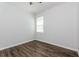 Bedroom with wood floor and window letting in natural light at 2430 Sanderling St, Haines City, FL 33844