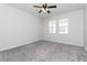 Bedroom with neutral carpet, ceiling fan and windows providing natural light at 2430 Sanderling St, Haines City, FL 33844