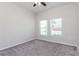 Bedroom with neutral carpet, ceiling fan and windows providing exterior views at 2430 Sanderling St, Haines City, FL 33844