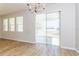 Dining space with wood-look tile floors, large windows, and a sliding door that lets in ample natural light at 2430 Sanderling St, Haines City, FL 33844