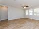 Bright living room featuring wood-look tile flooring and multiple windows for natural light at 2430 Sanderling St, Haines City, FL 33844