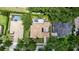 Aerial view of the estate featuring a pool, lush trees, and elegant architectural design at 25813 Feather Ridge Ln, Sorrento, FL 32776