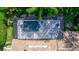 An aerial shot features the backyard pool, screened in and surrounded by lush greenery at 25813 Feather Ridge Ln, Sorrento, FL 32776