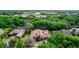 Beautiful aerial view of a home surrounded by green trees and a pond in the background at 25813 Feather Ridge Ln, Sorrento, FL 32776