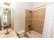 Cozy bathroom with a tiled shower, bronze fixtures, and a view into the bedroom at 25813 Feather Ridge Ln, Sorrento, FL 32776