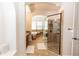 Elegant bathroom showcasing a glass shower and a soaking tub, with tile flooring and arched entryway at 25813 Feather Ridge Ln, Sorrento, FL 32776
