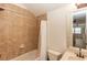 Bathroom featuring a shower-tub combination with neutral tile, and a white sink at 25813 Feather Ridge Ln, Sorrento, FL 32776