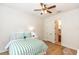 Bright bedroom features a ceiling fan, wood floors and ensuite bathroom at 25813 Feather Ridge Ln, Sorrento, FL 32776