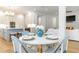 Charming breakfast nook adjacent to the kitchen with views of the fireplace and living room at 25813 Feather Ridge Ln, Sorrento, FL 32776