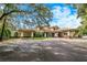Exterior view of the community clubhouse with ample parking and inviting entrance at 25813 Feather Ridge Ln, Sorrento, FL 32776