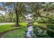 Scenic view of the community gathering space with manicured landscaping and waterfront views at 25813 Feather Ridge Ln, Sorrento, FL 32776
