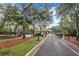 A gated community entrance surrounded by lush trees and landscaping, providing security and natural beauty at 25813 Feather Ridge Ln, Sorrento, FL 32776