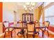 Well appointed dining room features hardwood floors, designer chandelier and large china cabinet at 25813 Feather Ridge Ln, Sorrento, FL 32776