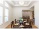 Elegant dining room with coffered ceilings, decorative wainscoting, hardwood floors, and chandelier at 25813 Feather Ridge Ln, Sorrento, FL 32776