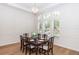 Bright dining room featuring hardwood floors, large windows, decorative wainscoting, coffered ceilings, and elegant lighting at 25813 Feather Ridge Ln, Sorrento, FL 32776