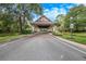 View of the community entrance with well-maintained landscaping and a covered entry at 25813 Feather Ridge Ln, Sorrento, FL 32776